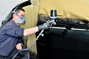 man respraying car